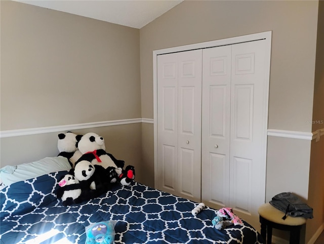 bedroom with a closet and lofted ceiling