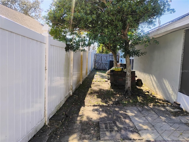 view of yard featuring cooling unit and fence