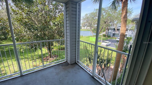 unfurnished sunroom with a water view