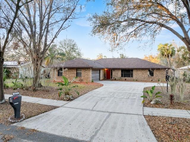 single story home with a garage and concrete driveway