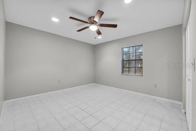 unfurnished room featuring ceiling fan, baseboards, and recessed lighting