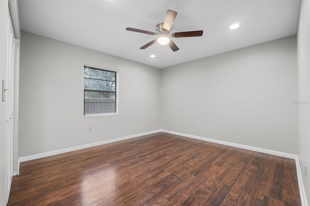 spare room featuring ceiling fan, dark wood-type flooring, recessed lighting, and baseboards