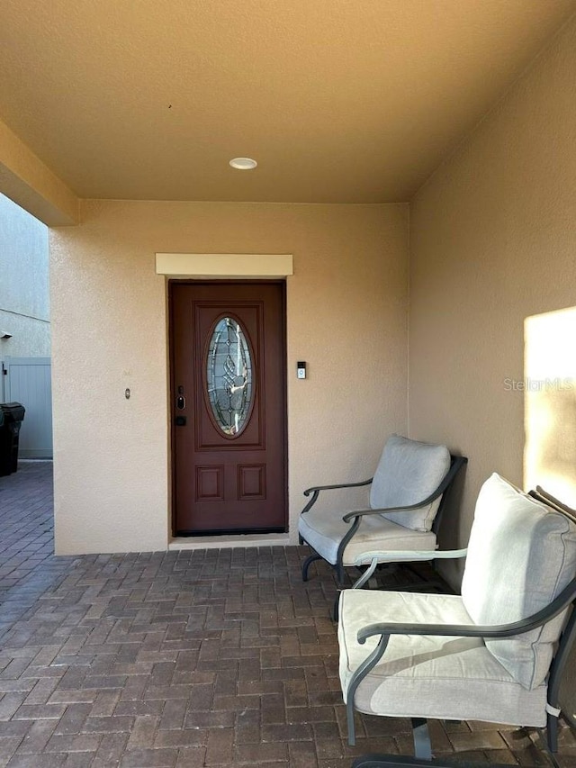 entrance to property with stucco siding