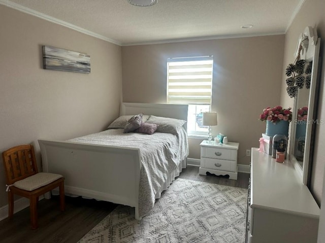 bedroom with ornamental molding, light wood finished floors, and baseboards