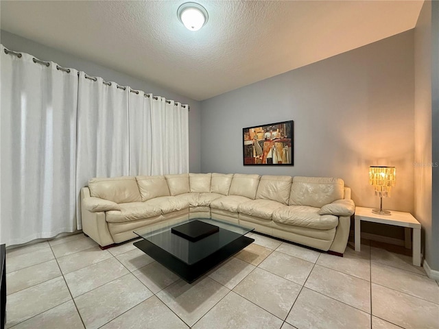 living area with light tile patterned floors and a textured ceiling