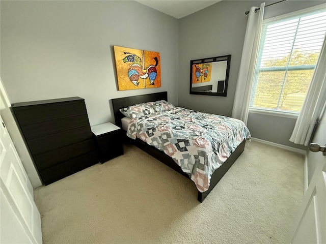 bedroom with carpet floors and baseboards