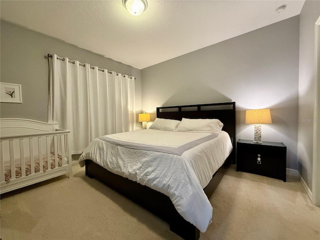 bedroom featuring carpet floors and baseboards