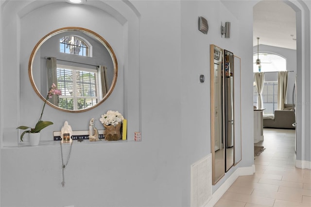 hallway featuring visible vents and arched walkways