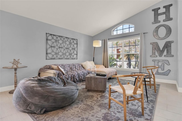 tiled living area featuring baseboards and vaulted ceiling