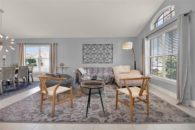 living room with vaulted ceiling, baseboards, and an inviting chandelier