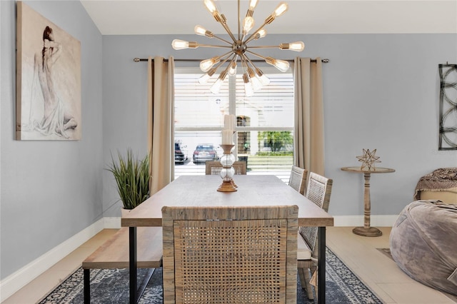 dining room featuring light tile patterned floors, baseboards, and a chandelier