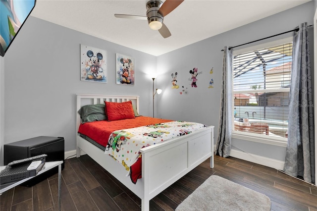 bedroom with a ceiling fan, wood tiled floor, and baseboards