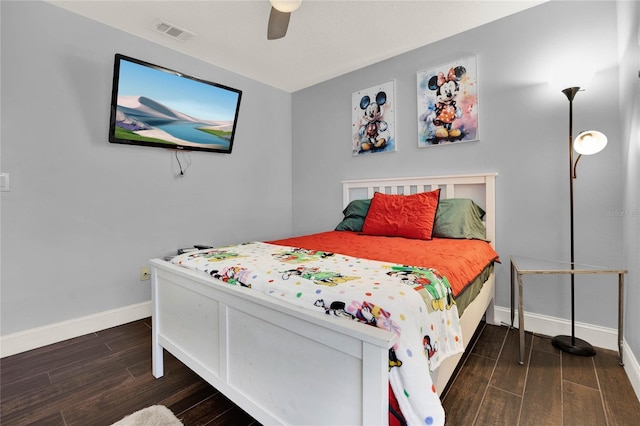 bedroom featuring visible vents, ceiling fan, baseboards, and wood finished floors