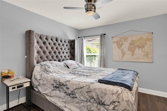 bedroom featuring ceiling fan, wood finished floors, and baseboards