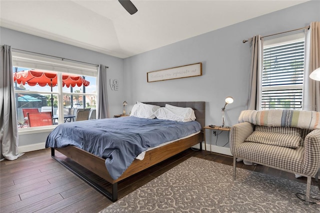 bedroom with lofted ceiling, wood finished floors, a ceiling fan, and baseboards