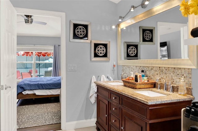 full bathroom with a sink, ensuite bath, decorative backsplash, and double vanity