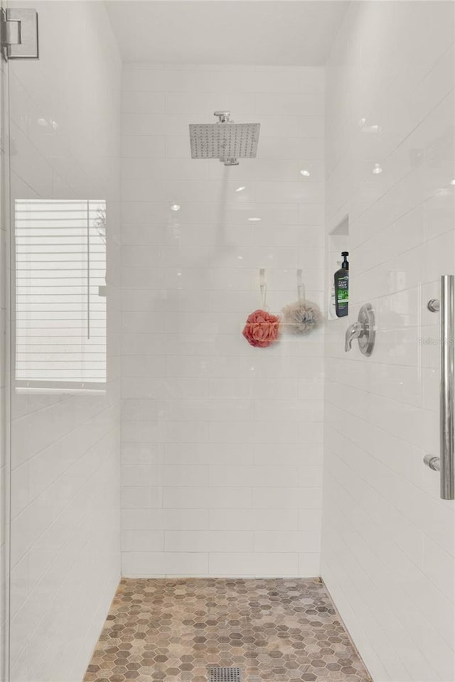 full bath featuring a tile shower