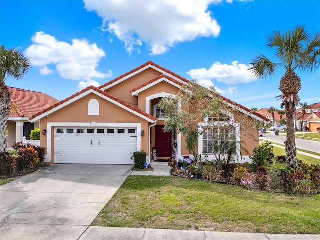 view of front of property with a front lawn, driveway, an attached garage, and stucco siding