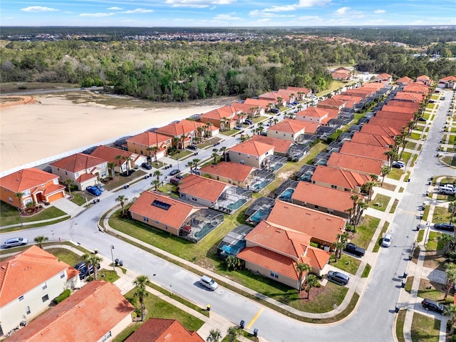 bird's eye view with a wooded view and a residential view