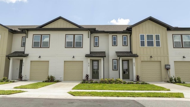 803 Longboat Dr, Davenport, FL 33896 - craftsman-style home featuring board and batten siding, an attached garage, a shingled roof, and driveway