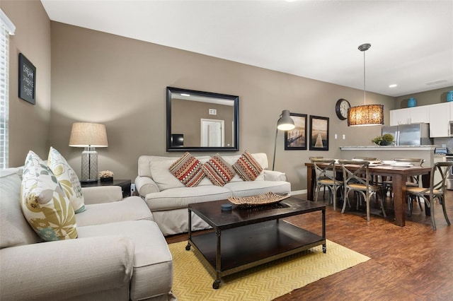 living area featuring baseboards and wood finished floors