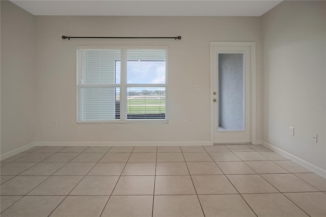 spare room with baseboards