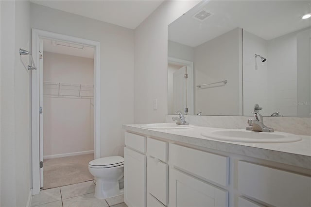 full bath with double vanity, a sink, visible vents, and tile patterned floors