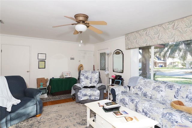 living room featuring ornamental molding, wood finished floors, and a ceiling fan