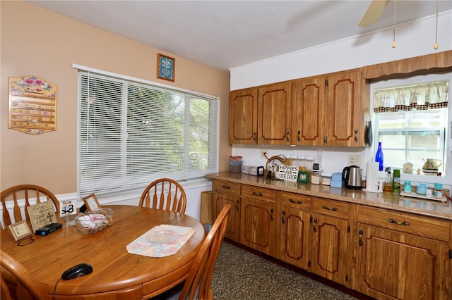 kitchen featuring brown cabinetry and a ceiling fan