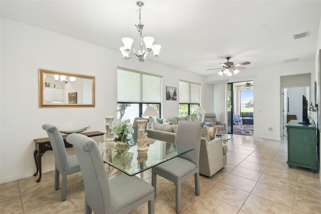 3390 Fallbrook Dr, Kissimmee, FL 34759 - dining space with light tile patterned floors, ceiling fan with notable chandelier, and visible vents