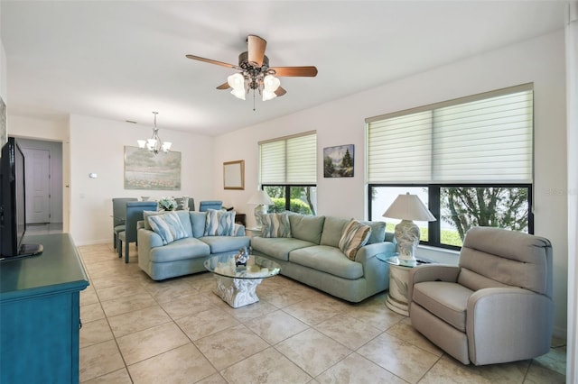 3390 Fallbrook Dr, Kissimmee, FL 34759 - living area featuring light tile patterned floors and ceiling fan with notable chandelier