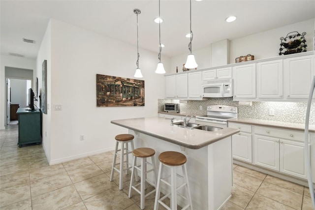3390 Fallbrook Dr, Kissimmee, FL 34759 - kitchen with visible vents, decorative backsplash, white cabinetry, a sink, and white appliances