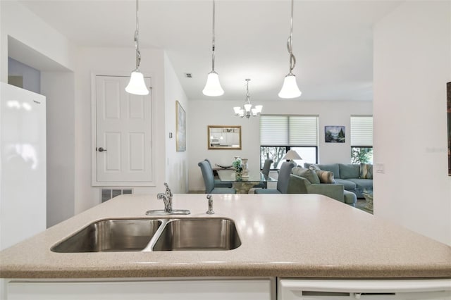 3390 Fallbrook Dr, Kissimmee, FL 34759 - kitchen featuring a sink, visible vents, open floor plan, freestanding refrigerator, and pendant lighting