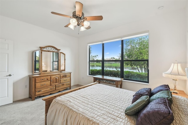 3390 Fallbrook Dr, Kissimmee, FL 34759 - bedroom with a water view, baseboards, carpet floors, and a ceiling fan