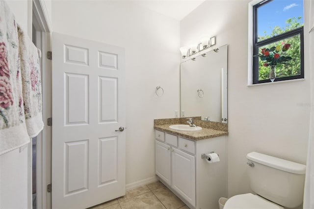 3390 Fallbrook Dr, Kissimmee, FL 34759 - half bathroom featuring toilet, tile patterned flooring, and vanity