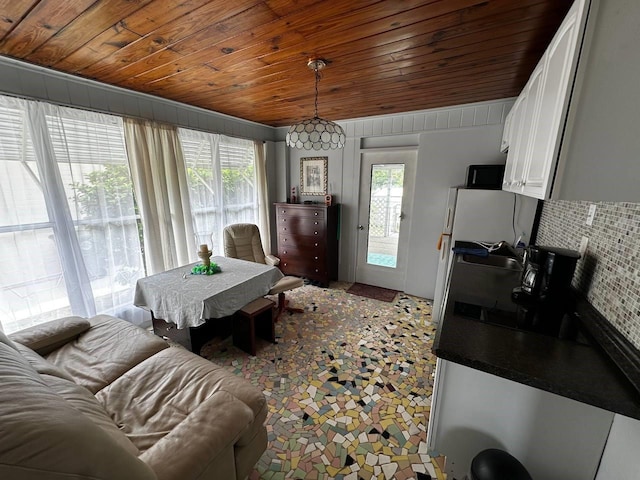 dining room with wooden ceiling and a healthy amount of sunlight