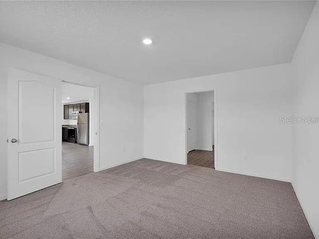 unfurnished room with carpet floors