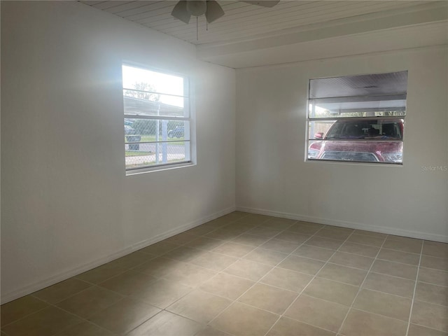 spare room with baseboards and a ceiling fan