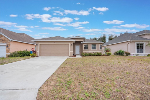 view of front facade with a garage, a front yard, driveway, and stucco siding