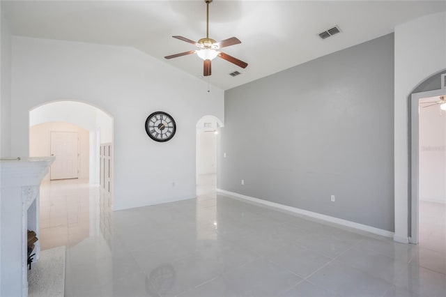 unfurnished room featuring a ceiling fan, arched walkways, visible vents, and lofted ceiling