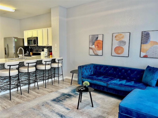 living area with light wood-style floors and baseboards