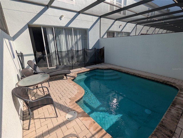 view of swimming pool with a lanai, a fenced in pool, and a patio