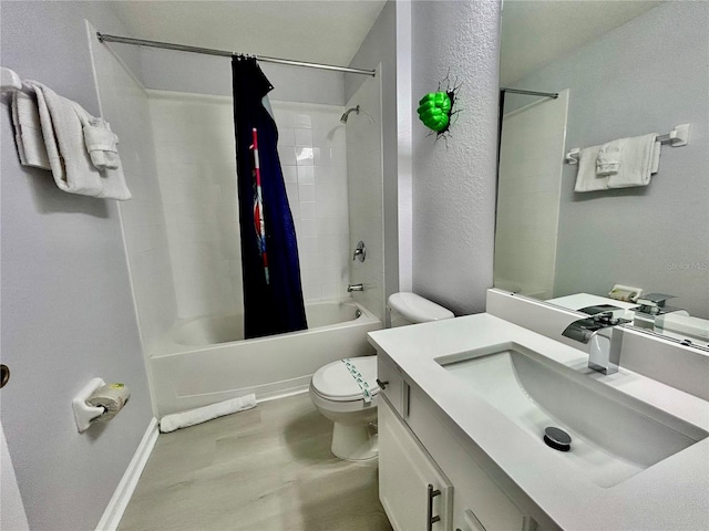 full bathroom featuring a textured wall, shower / bathtub combination with curtain, toilet, vanity, and wood finished floors