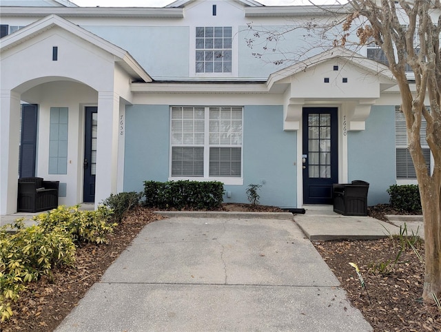 property entrance featuring stucco siding