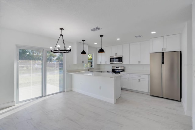 kitchen featuring stainless steel appliances, a peninsula, visible vents, white cabinetry, and light countertops