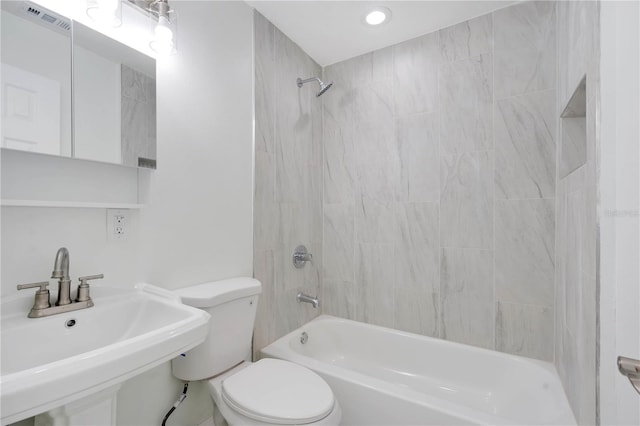 full bathroom with bathtub / shower combination, visible vents, a sink, and toilet