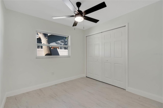 unfurnished bedroom featuring a closet, ceiling fan, and baseboards