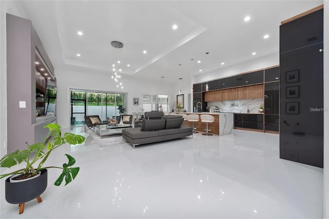 living room featuring a raised ceiling and recessed lighting