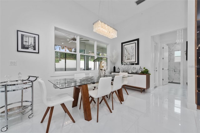 dining area featuring marble finish floor, visible vents, and a ceiling fan