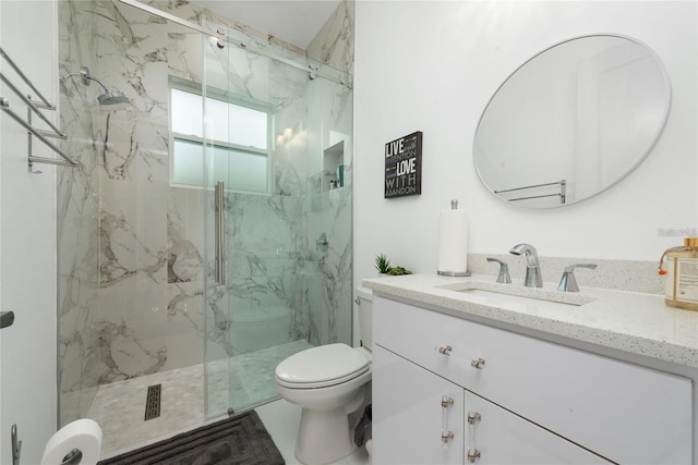 full bathroom featuring a marble finish shower, vanity, and toilet